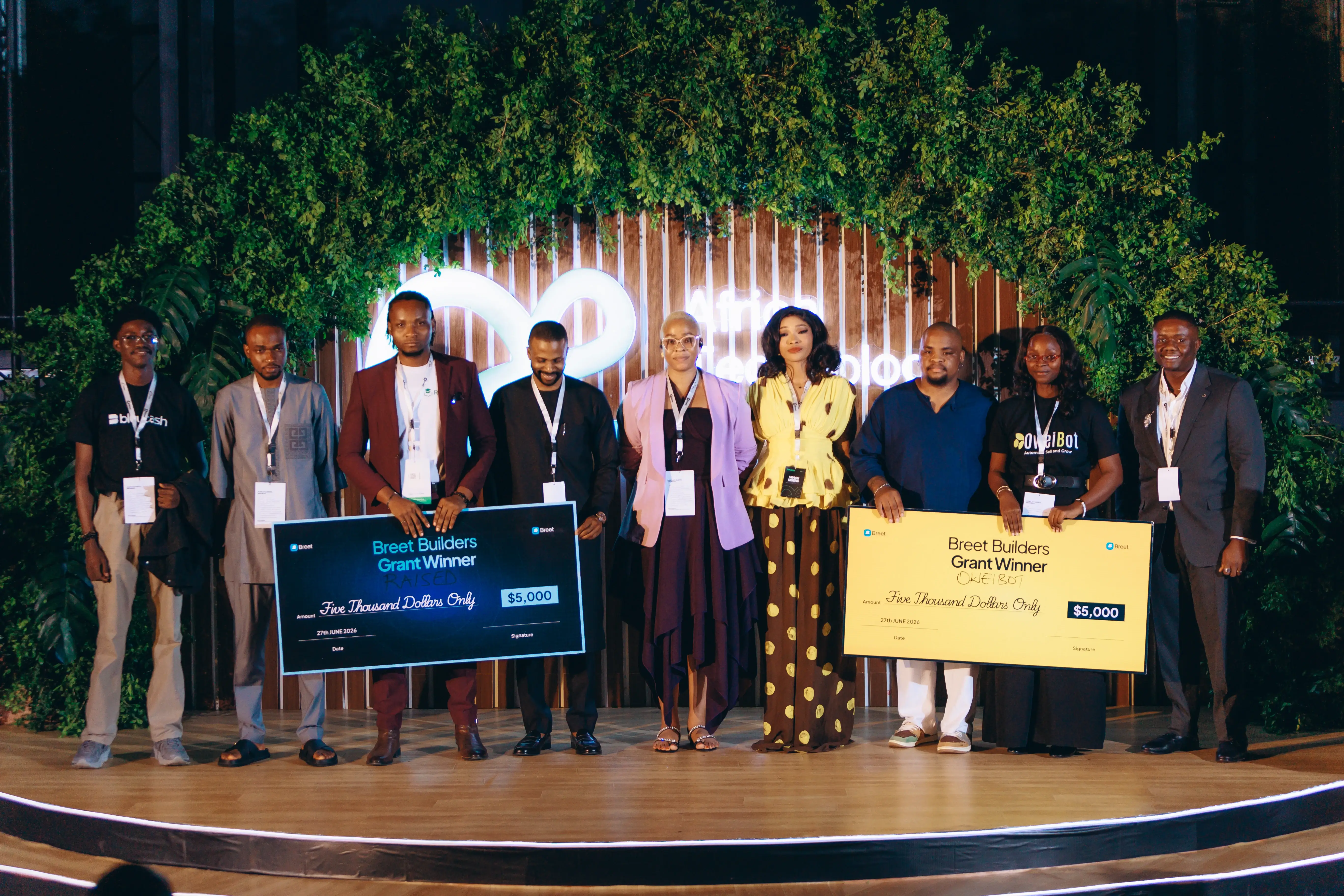 Breet Builders Grant winners on stage holding their prize cheques