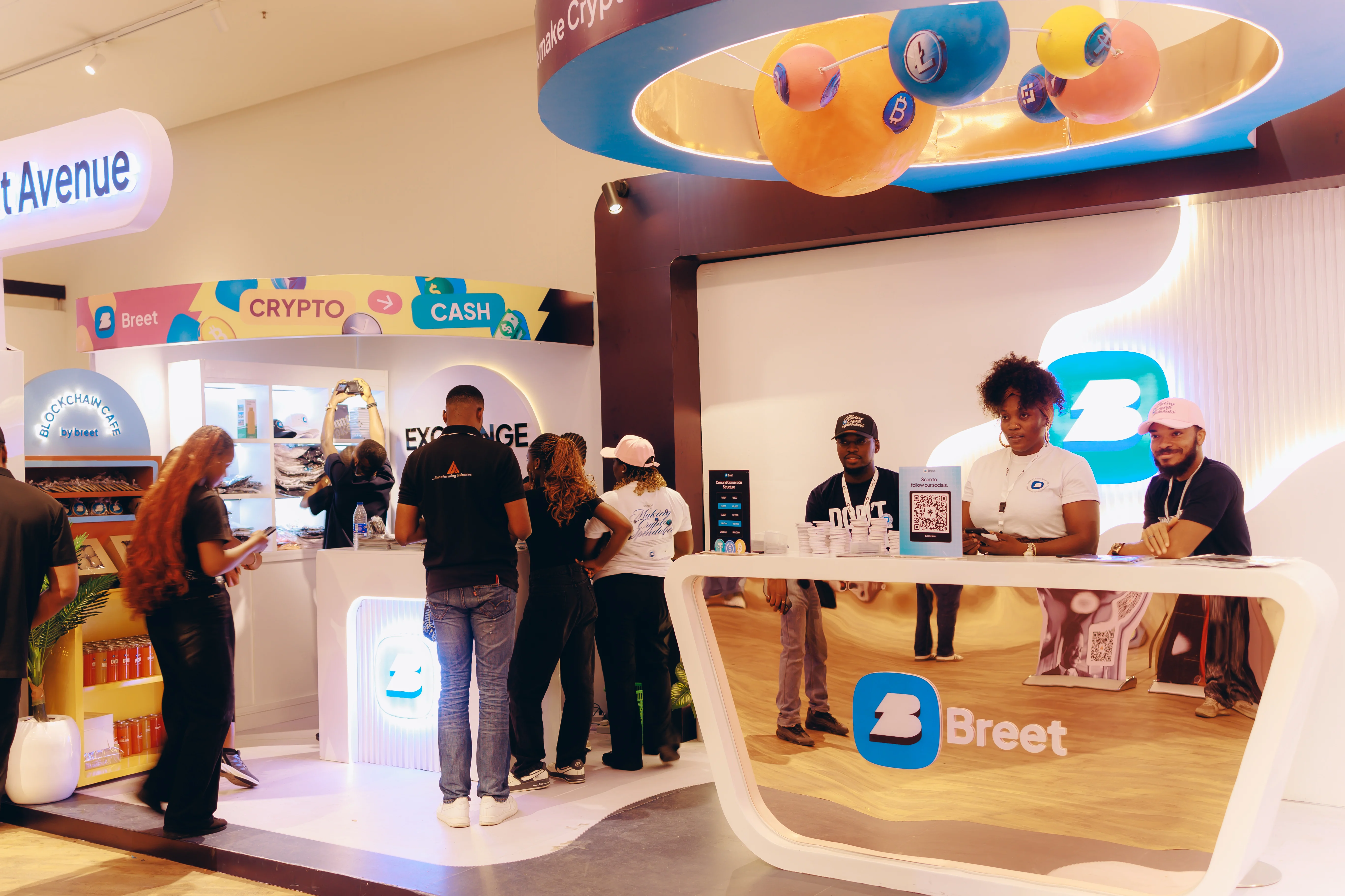 Attendees at the Breet exhibition stand, with crypto and cash exchange displays
